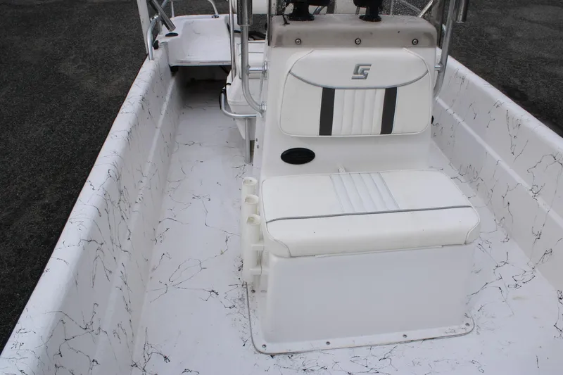 Slide: The Image of 2009 Carolina Skiff 17 DLX boat interior with white seating and console. - 14