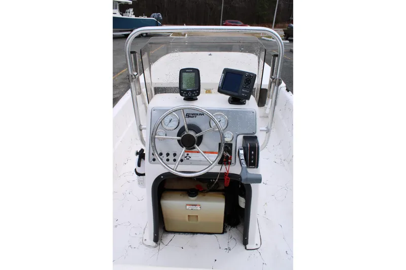 Slide: The Image of 2009 Carolina Skiff 17 DLX boat console with steering wheel and navigation equipment. - 16