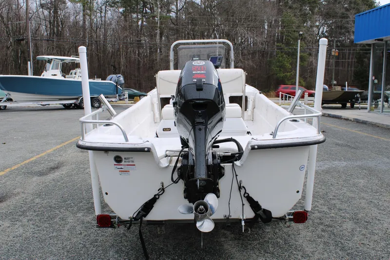 Slide: The Image of 2009 Carolina Skiff 17 DLX boat with outboard motor, parked outdoors. - 6