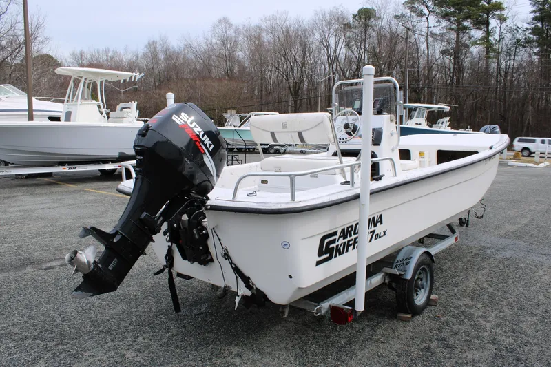 Slide: The Image of 2009 Carolina Skiff 17 DLX boat with Suzuki outboard motor on trailer. - 7