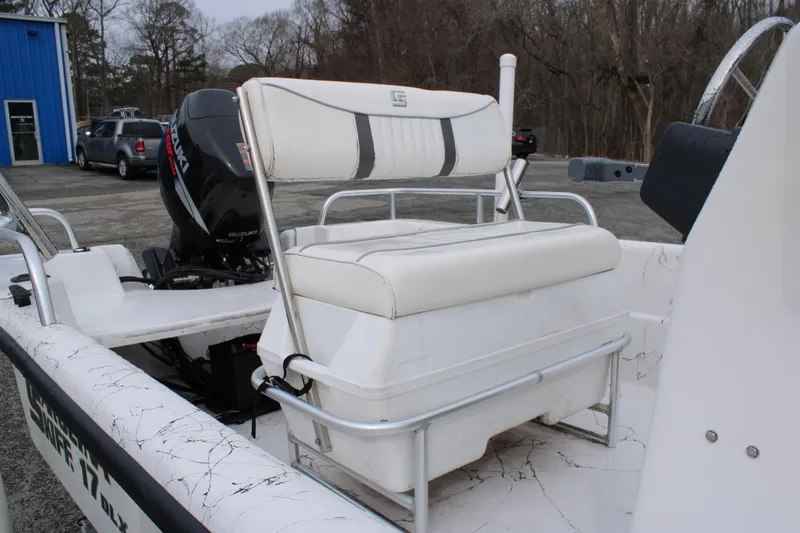 Slide: The Image of 2009 Carolina Skiff 17 DLX boat with Suzuki outboard motor and white seating. - 9