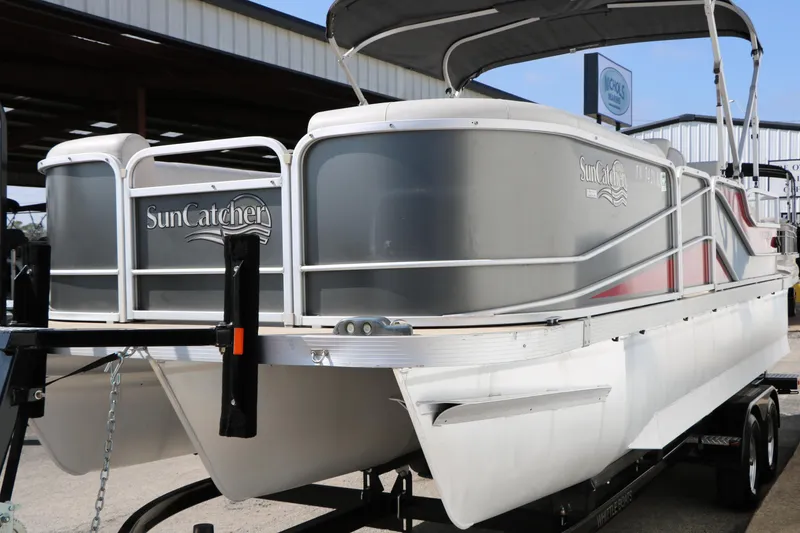 Slide: The Image of 2019 SunCatcher V322 RC pontoon boat on trailer, parked outdoors. - 7