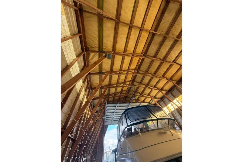 Slide: The Image of 1940 custom boathouse interior with wooden beams and docked boat. - 11