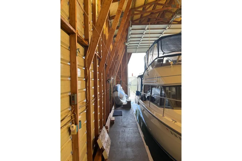 Slide: The Image of 1940 custom boathouse interior with wooden beams and docked boat. - 12