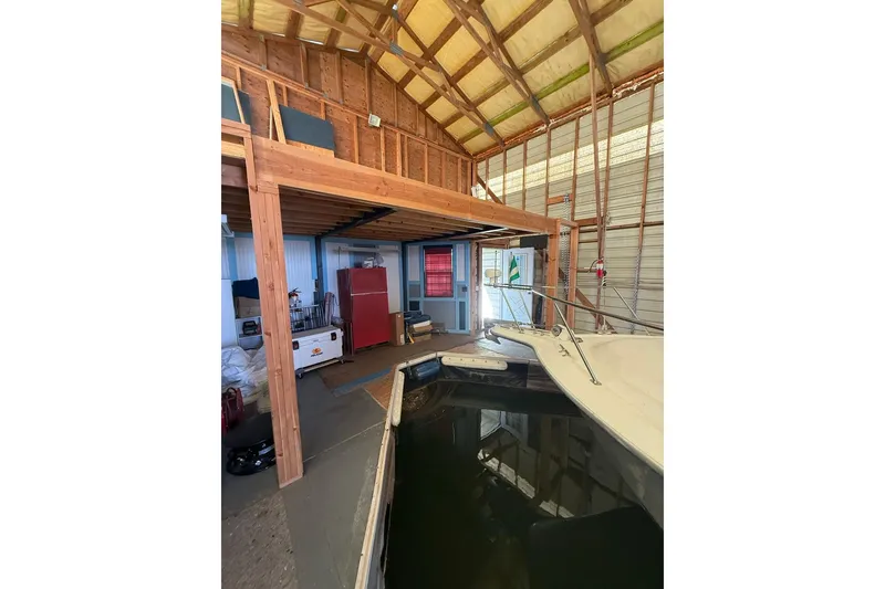 Slide: The Image of 1940 custom boathouse interior with docked boat and wooden loft. - 15