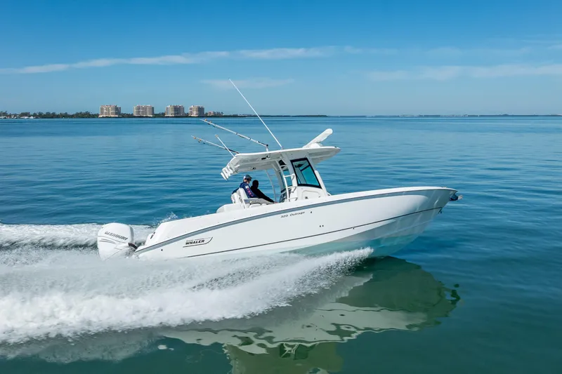 Slide: The Image of 2013 Boston Whaler 320 Outrage cruising on calm blue waters. - 2