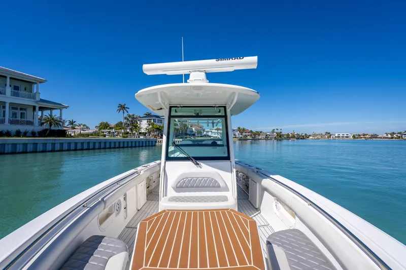 Slide: The Image of 2013 Boston Whaler 320 Outrage boat on calm water, clear blue sky background. - 20