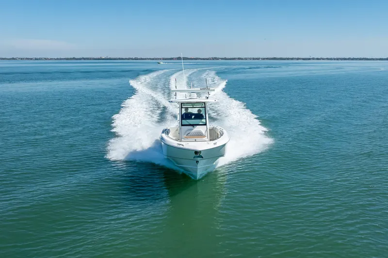 Slide: The Image of 2013 Boston Whaler 320 Outrage cruising on open water, creating a wake. - 3