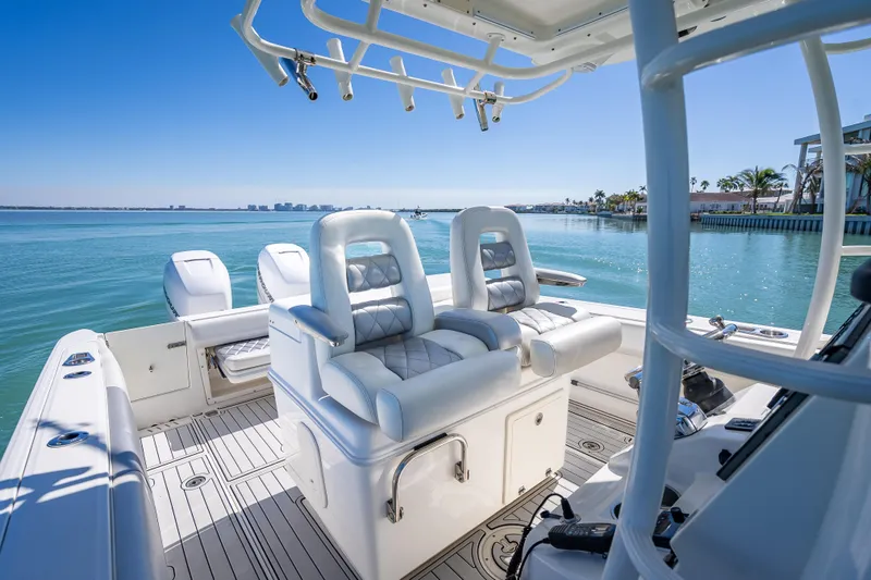 Slide: The Image of 2013 Boston Whaler 320 Outrage boat interior with luxurious seating and ocean view. - 32