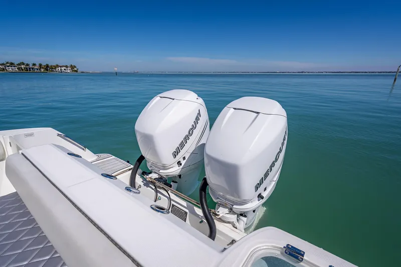 Slide: The Image of 2013 Boston Whaler 320 Outrage with twin Mercury outboard engines on calm water. - 37