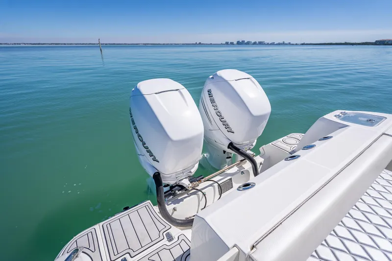 Slide: The Image of 2013 Boston Whaler 320 Outrage with twin Mercury outboard engines on calm water. - 38