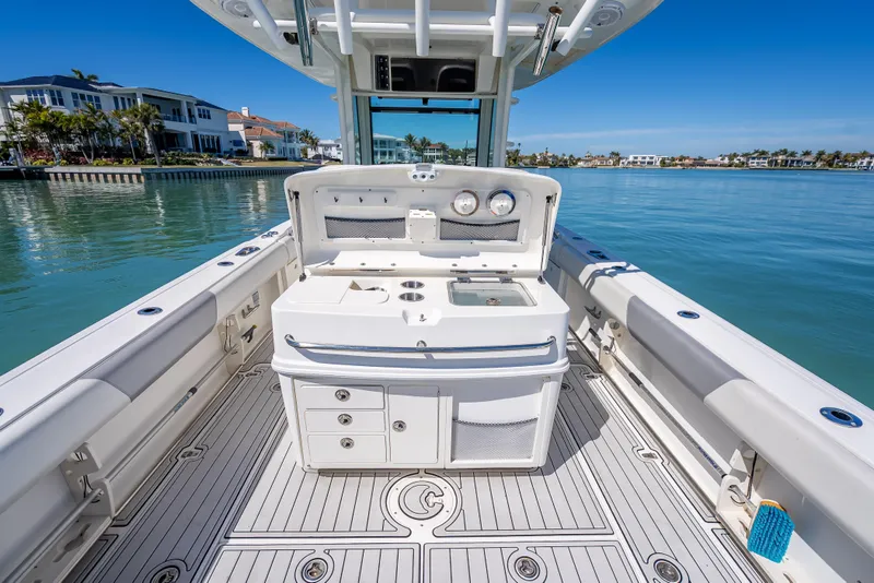 Slide: The Image of 2013 Boston Whaler 320 Outrage boat interior with fishing station, docked by waterfront homes. - 40