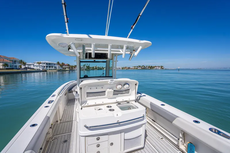 Slide: The Image of 2013 Boston Whaler 320 Outrage boat on calm water, clear blue sky background. - 43