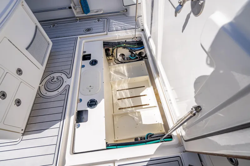 Slide: The Image of 2013 Boston Whaler 320 Outrage boat deck with open storage compartment. - 46