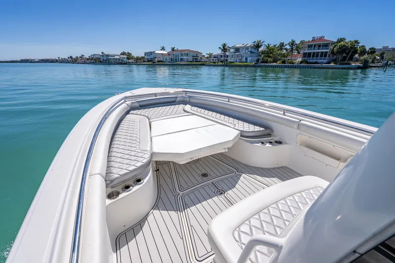 Slide: The Image of 2013 Boston Whaler 320 Outrage boat interior with luxurious seating and ocean view. - 49