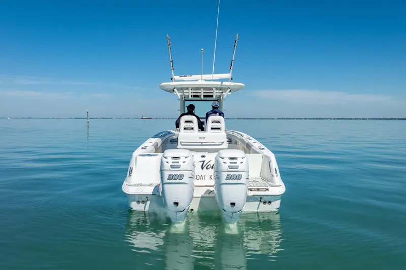 Slide: The Image of 2013 Boston Whaler 320 Outrage on calm water, rear view with dual engines. - 6