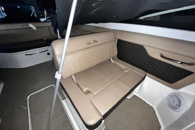 Slide: The Image of 2018 Sea Ray 270 Sundeck interior with beige seating and stylish design. - 10