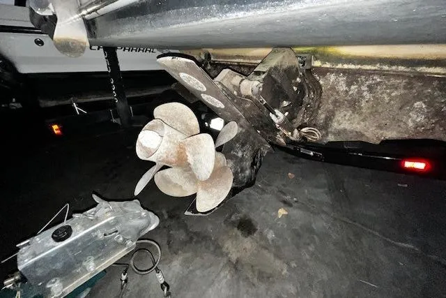 Slide: The Image of 2018 Sea Ray 270 Sundeck boat propeller and stern drive in a dimly lit setting. - 25