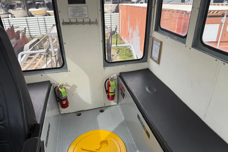 Slide: The Image of Interior of 2010 Custom Aluminum Work Boat 34x10 with fire extinguishers and seating. - 11
