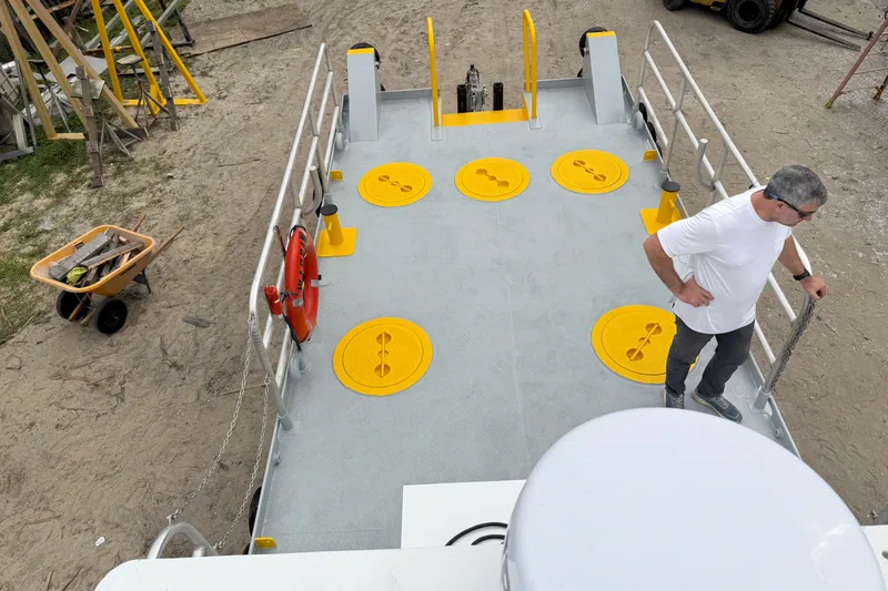 Slide: The Image of Custom Aluminum Work Boat 34x10, 2010 model, with yellow hatches and safety equipment on deck. - 13