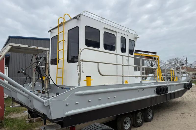 Slide: The Image of Custom Aluminum Work Boat 34x10, 2010 model, docked with visible equipment and safety features. - 6