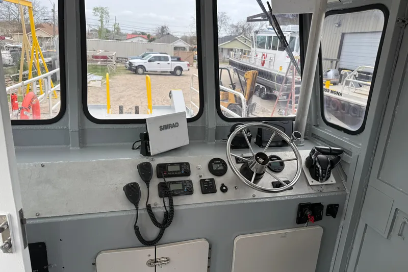 Slide: The Image of Interior of 2010 Custom Aluminum Work Boat 34x10 with steering wheel and navigation equipment. - 8