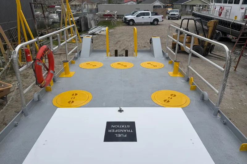 Slide: The Image of Custom Aluminum Work Boat 34x10, 2010 model, featuring deck with safety railings and equipment. - 9