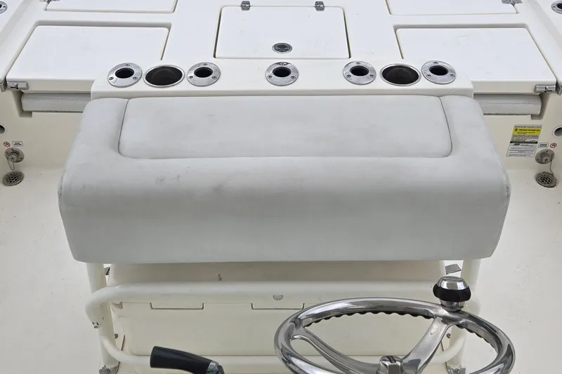 Slide: The Image of 2022 Pathfinder 2400 TRS boat console with cushioned seat and multiple cup holders. - 11