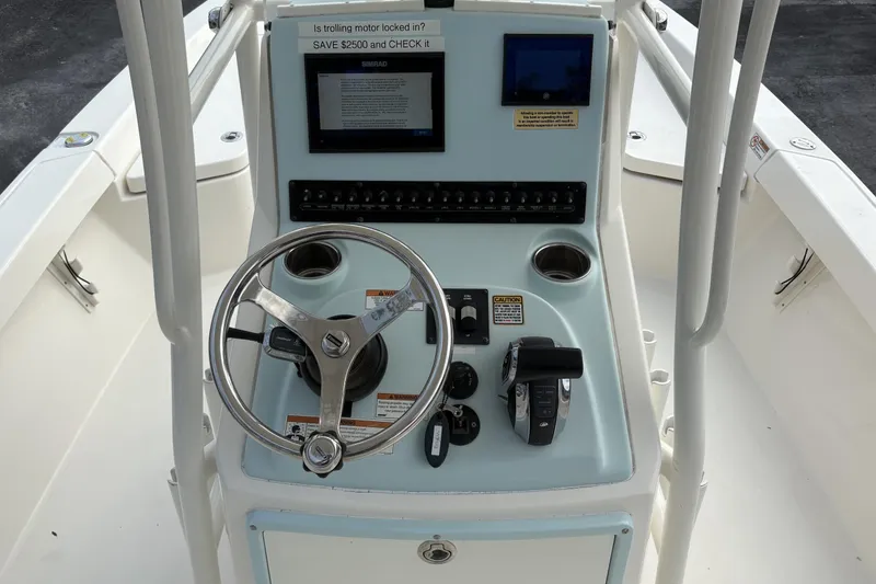 Slide: The Image of 2022 Pathfinder 2400 TRS boat console with steering wheel and controls. - 7