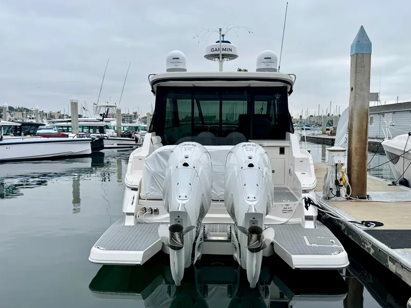 Slide: The Image of 2026 Regal 36 XO yacht docked with twin outboard engines in a marina. - 14