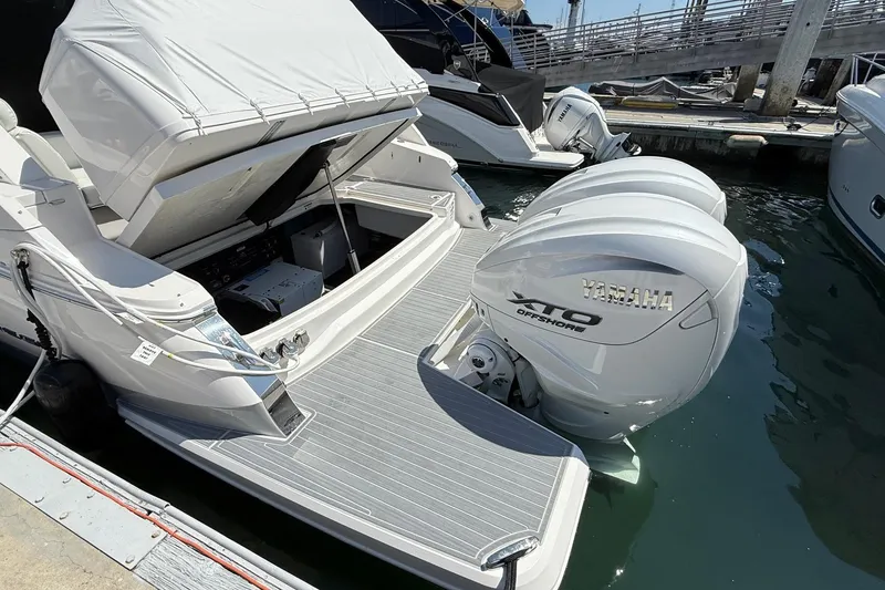 Slide: The Image of 2026 Regal 36 XO boat with Yamaha XTO Offshore engines docked at marina. - 16