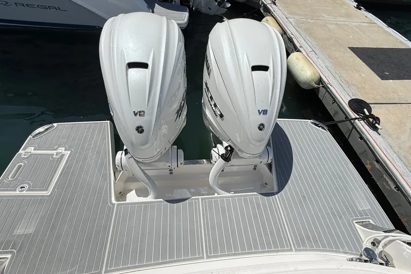 Slide: The Image of 2026 Regal 36 XO boat with twin V8 outboard engines at dock. - 20