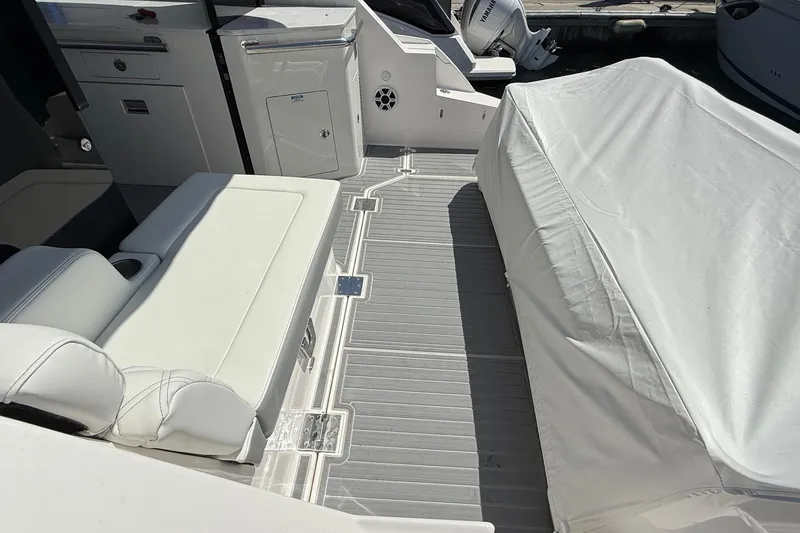 Slide: The Image of 2026 Regal 36 XO boat interior with white seating and covered deck area. - 22
