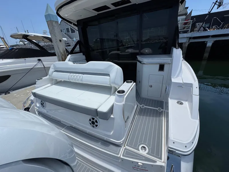 Slide: The Image of 2026 Regal 36 XO yacht's rear deck with seating and sleek design. - 24
