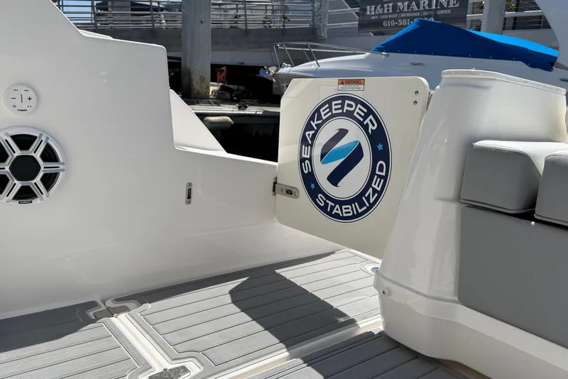 Slide: The Image of 2026 Regal 36 XO boat featuring Seakeeper stabilization system at dock. - 32