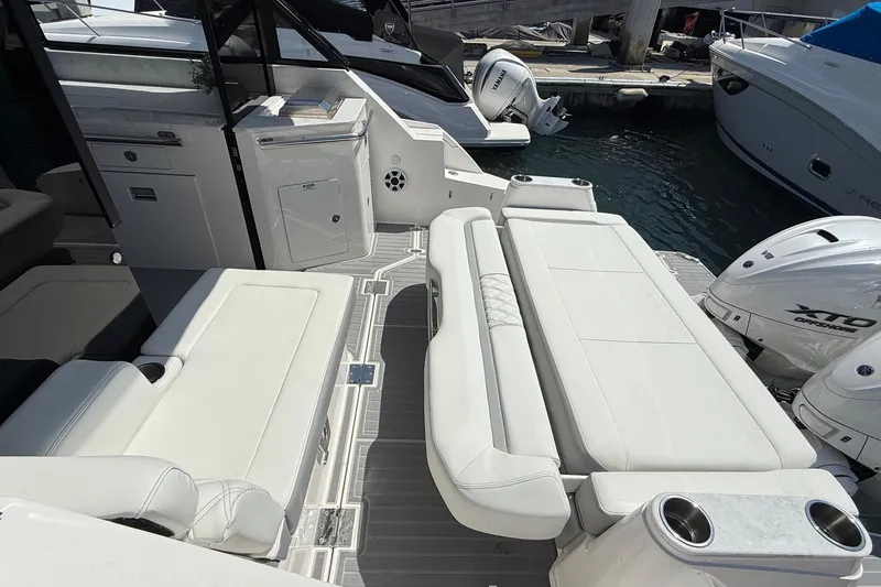 Slide: The Image of 2026 Regal 36 XO yacht interior with white seating and modern amenities. - 34
