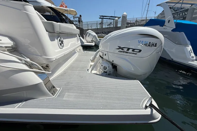 Slide: The Image of 2026 Regal 36 XO yacht with Yamaha XTO Offshore engine at marina dock. - 36