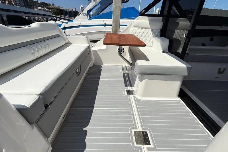 Slide: The Image of Luxurious seating area on 2026 Regal 36 XO yacht with elegant wood table. - 37