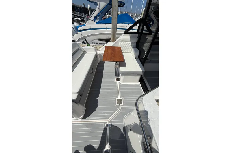 Slide: The Image of 2026 Regal 36 XO boat interior with seating and wooden table. - 38