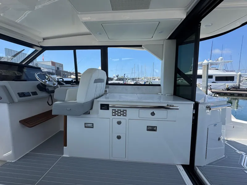 Slide: The Image of Interior of 2026 Regal 36 XO yacht with helm and marina view. - 49