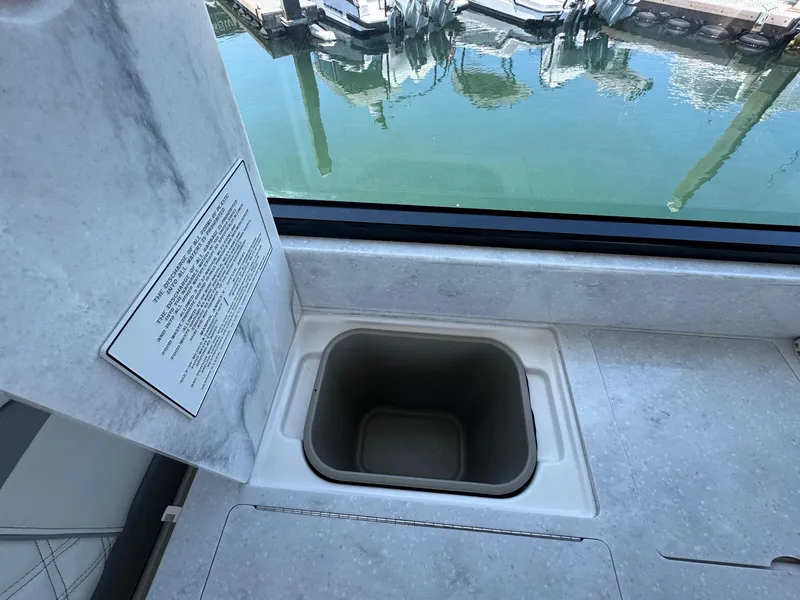 Slide: The Image of 2026 Regal 36 XO boat interior with built-in sink and marina view. - 51