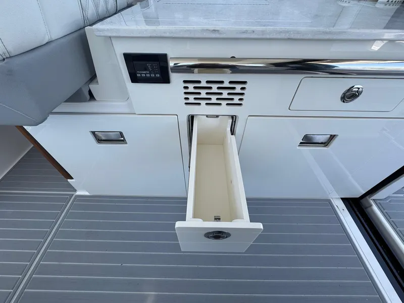 Slide: The Image of Open drawer on 2026 Regal 36 XO boat with sleek white cabinetry. - 54