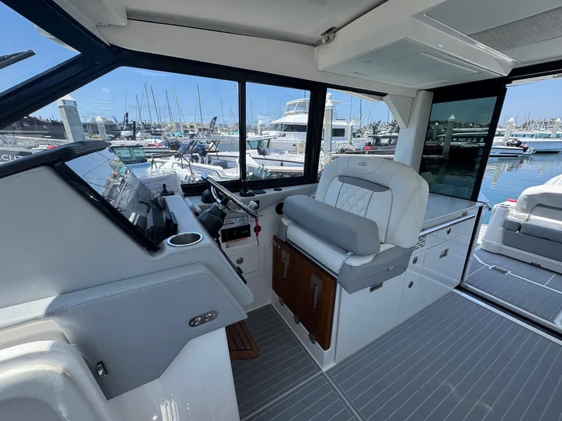 Slide: The Image of Interior view of 2026 Regal 36 XO yacht cockpit with marina background. - 58