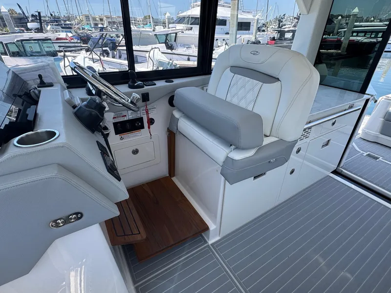 Slide: The Image of Helm station of 2026 Regal 36 XO yacht with modern controls and seating. - 59
