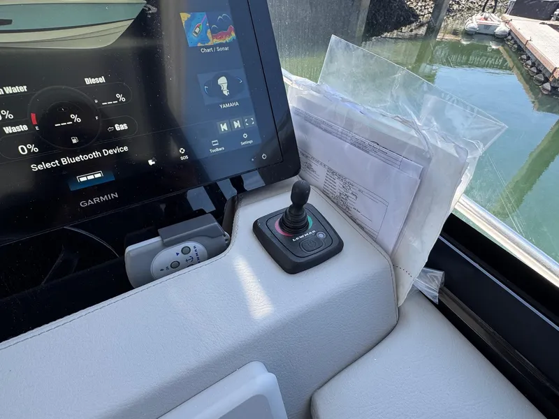 Slide: The Image of Control panel of 2026 Regal 36 XO boat with Garmin display and joystick. - 61
