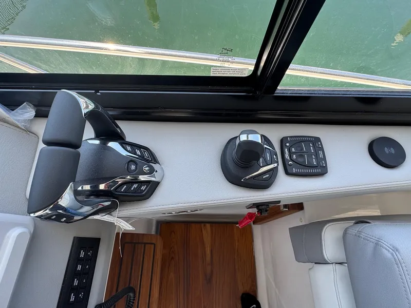 Slide: The Image of Control panel of 2026 Regal 36 XO boat with joystick and throttle. - 62