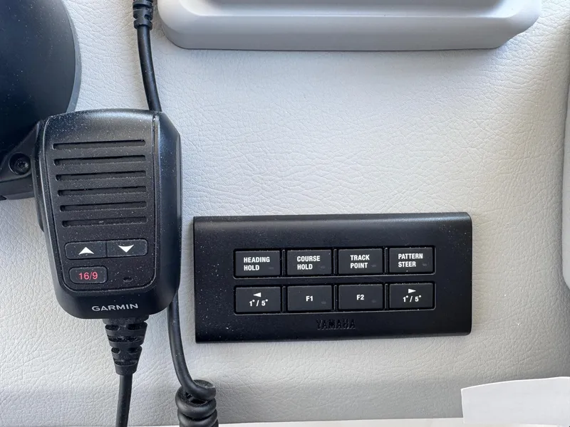 Slide: The Image of Control panel and Garmin device on 2026 Regal 36 XO boat dashboard. - 63