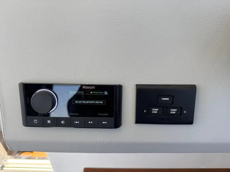 Slide: The Image of Control panel of a 2026 Regal 36 XO boat with audio and power switches. - 64