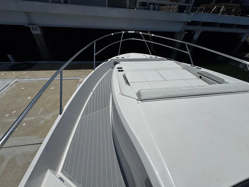 Slide: The Image of 2026 Regal 36 XO yacht with sleek deck and sunbathing area. - 71