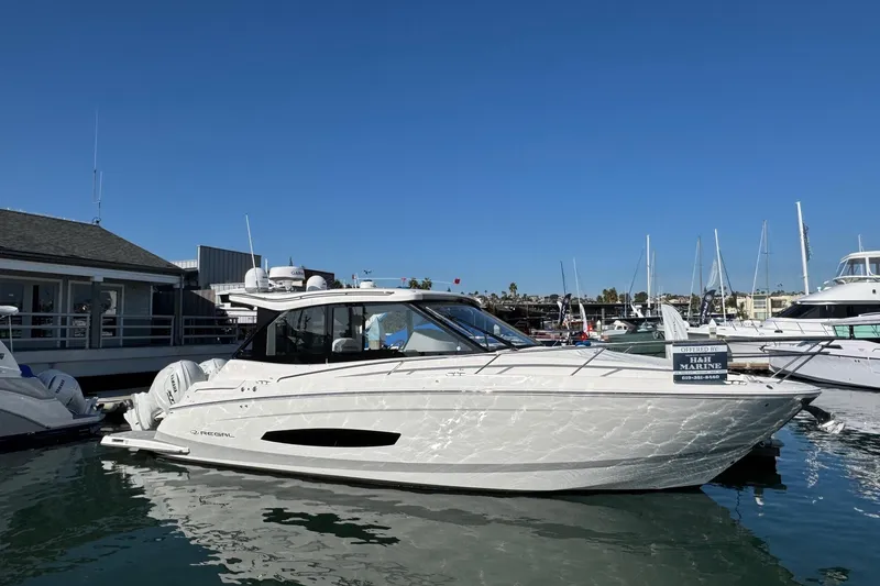 Slide: The Image of 2026 Regal 36 XO yacht docked at marina under clear blue sky. - 8